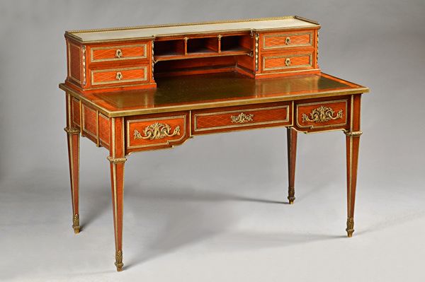 In the manner of Jean Henri Riesener; a late 19th century ormolu mounted mahogany writing desk of Louis XVI style, the marble top superstructure with