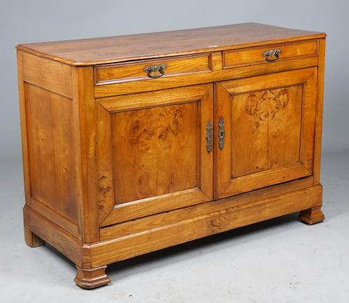 An early 19th century French figured oak buffet with a pair of drawers over panel cupboards on canted ogee bracket feet, 138cm wide x 98cm high.