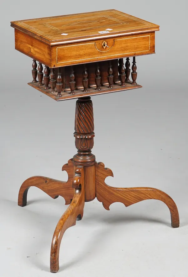 An early 19th century Anglo Indian ivory inlaid teak sewing box, the rectangular lid revealing a fitted interior over a bobbin turned gallery on spira