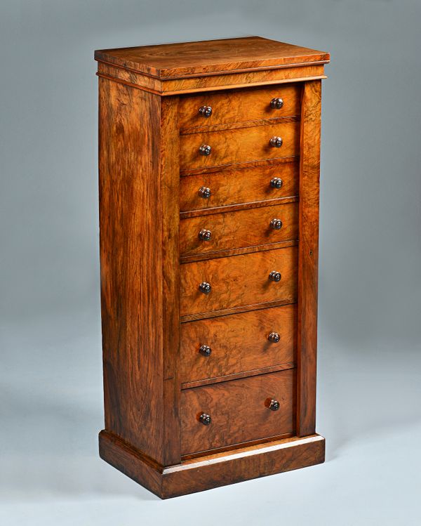 A Victorian figured walnut secretaire Wellington chest with five graduated true drawers and two dummy fall drawers enclosing a fitted interior, all en