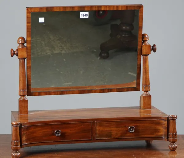 A William IV mahogany toilet mirror, the concave two drawer base with outstepped lappet carved supports on melon feet, 64cm wide x 54cm high.