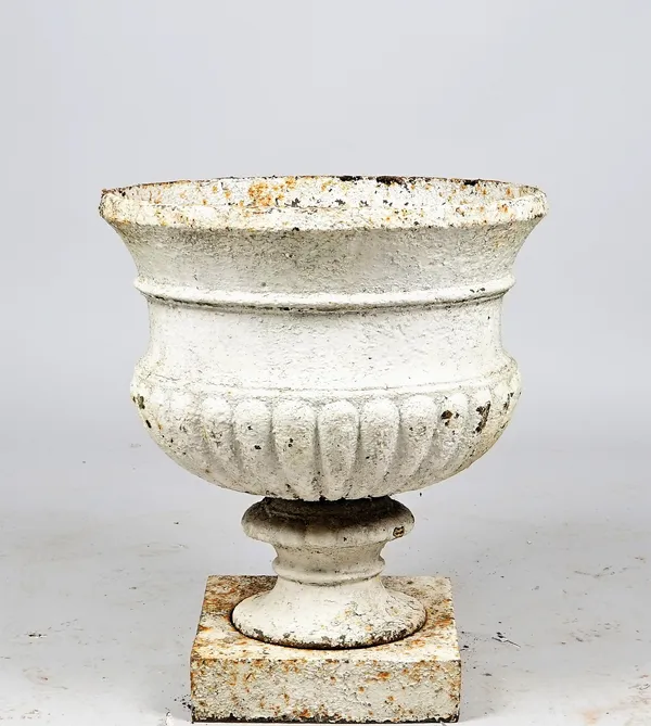 A Victorian white painted cast iron jardiniere with semi fluted body on turned socle and square base, 51cm diameter x 60cm high.