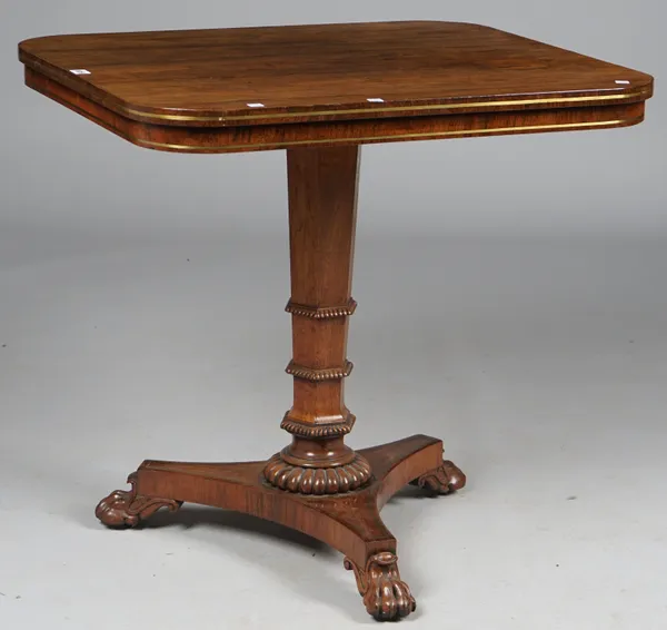 A William IV rosewood centre table, the rectangular top with brass strung frieze on tapering hexagonal column and three paw feet, 78cm wide x 76cm hig