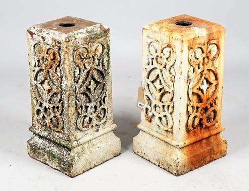 A pair of white painted wrought iron pedestals, with relief wriggle work mounts, 30cm wide x 62cm high.
