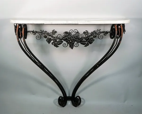 A French Art Deco console, the marble top on fruiting vine chased dual wrought iron scroll supports, 107cm wide x 95cm high.