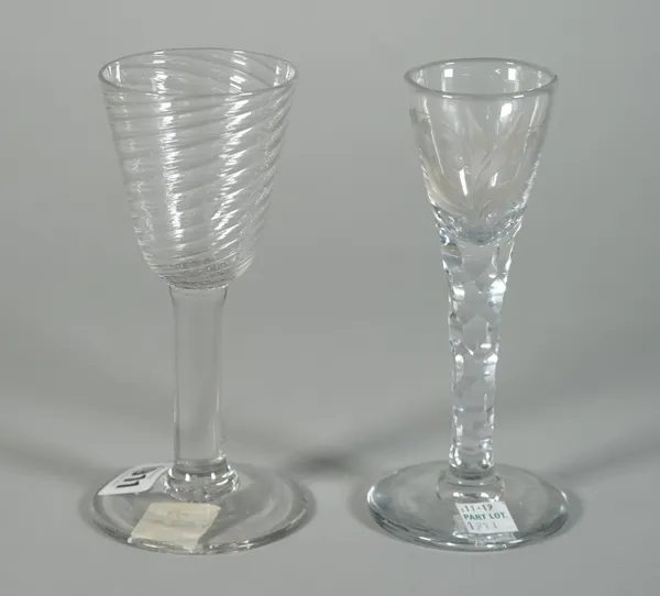 A plain stemmed wine glass, mid-18th century, with wrythen moulded rounded funnel bowl, 16cm high; and a facet stem wine glass engraved with lily of t