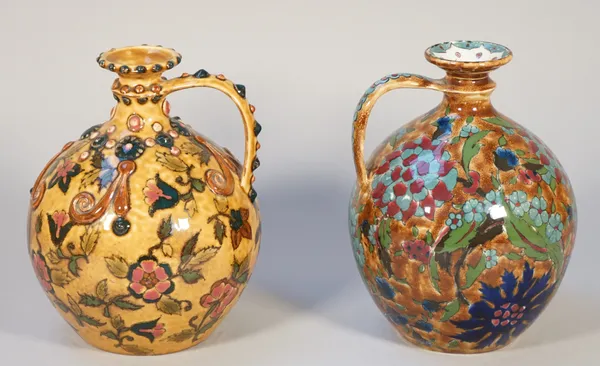 A Zsolnay Pecs ewer, early 20th century, decorated with flowers against a mottled buff ground, relief moulding to the handle and neck, 20cm high and a