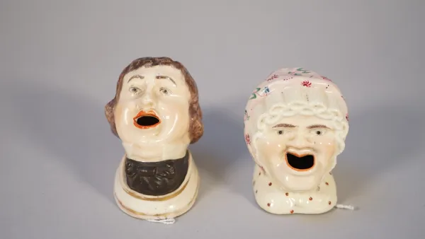 A pair of mid-19th century Staffordshire figural inkwells, each modelled with mouth open to supply ink, 7cm high, (a.f.)