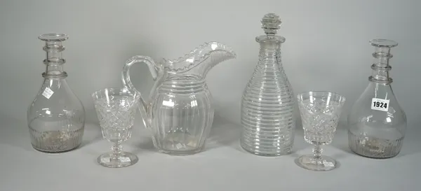 A group of glassware, 19th century, comprising; a pair of moulded triple-ring neck decanters, 22.5cm. high; a step cut decanter and stopper, 27.5cm hi