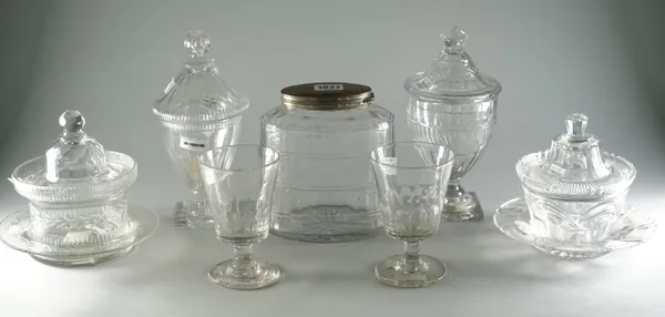 A group of glassware, 19th century, comprising; an oval facet cut tea caddy with silver plated hinged cover, 17cm. high; two cut glass butter dishes,