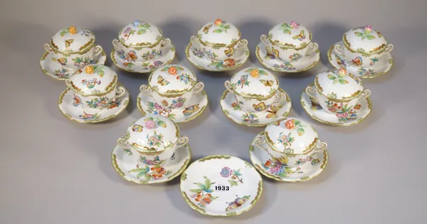 A part set of Herend porcelain chocolate cups, covers and stands, foliate decorated against a basket weave ground, blue printed marks, comprising elev