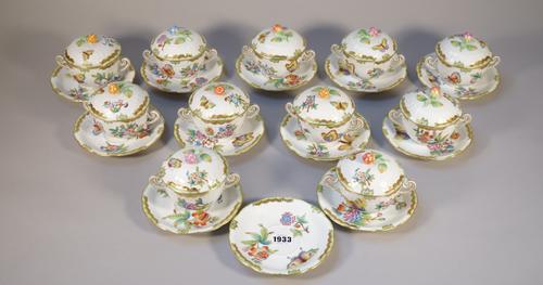 A part set of Herend porcelain chocolate cups, covers and stands, foliate decorated against a basket weave ground, blue printed marks, comprising elev