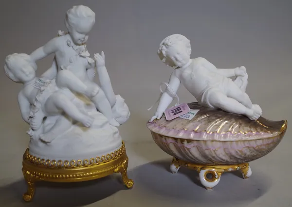 A 20th century bisque figure of three cherubs on gilt metal base and another on a shell base, 15cm high.