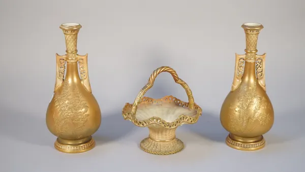 A pair of Royal Worcester two-handled vases, circa 1900, of Persian inspiration, each elongated pear shaped body moulded with ferns on a metallic gold