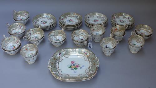 A Davenport porcelain part tea and coffee service, circa 1840, painted with flower groups inside an eau de nil and gilt foliate border, comprising; th