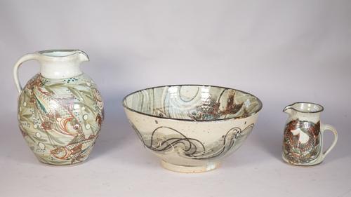 Colin Kellam (born 1942), a stoneware jug, basin and a smaller jug, each painted in iron-red, blue, brown and green with swimming fish, impressed seal