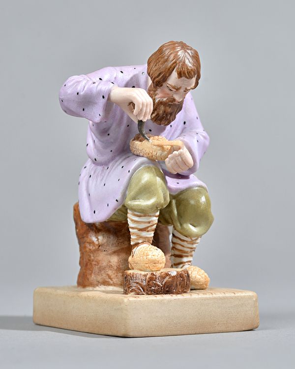 A Russian biscuit porcelain figure of a Lapti Player, Gardner factory, late 19th century, printed red factory mark, 11cm high. Illustrated