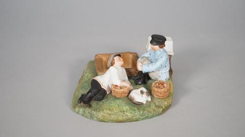 A Russian biscuit porcelain figure group, Gardner factory, late 19th century, modelled as two boys collecting mushrooms on a naturalistic base, printe