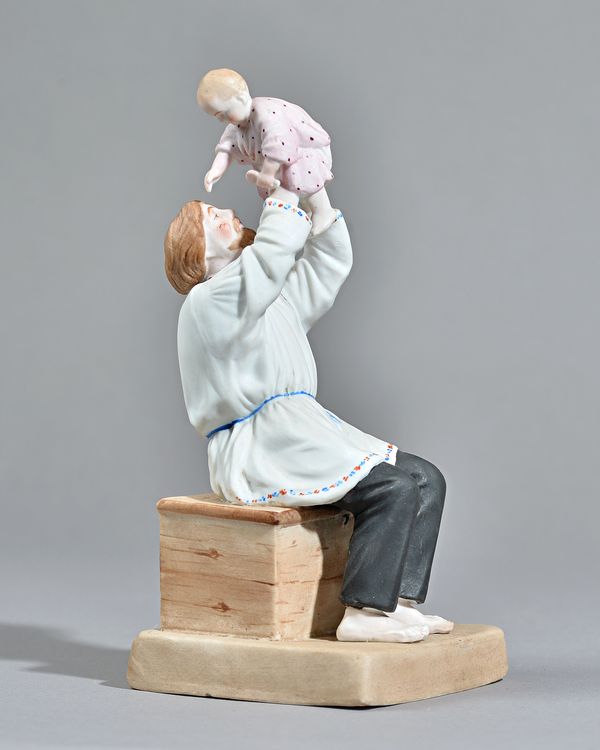 A Russian biscuit porcelain figure group of a father and child, Gardner factory, late 19th century, red factory mark, 21.5cm high. Illustrated