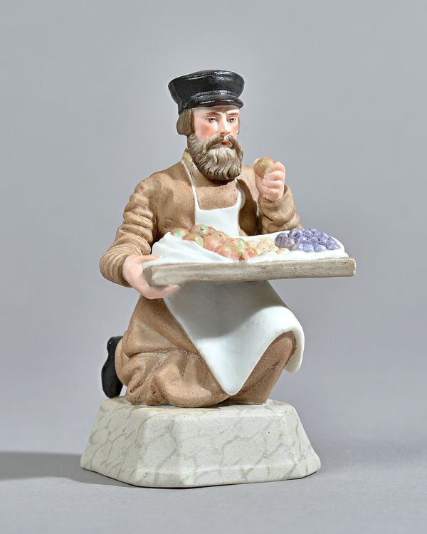 A Russian biscuit porcelain figure of a fruit vendor, Gardner factory, late 19th century, red printed factory mark, 12cm high. Illustrated