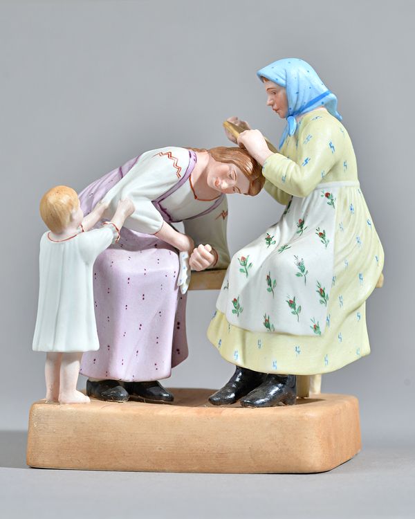 A Russian biscuit porcelain figure group depicting hair combing, Gardner factory, late 19th century, red printed mark, 17.5cm high. Illustrated