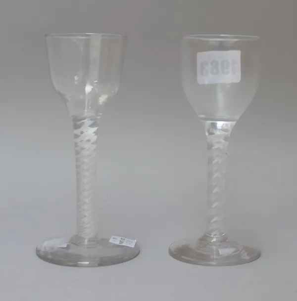 Two opaque twist wine glasses, circa 1765, each with ogee bowl raised on a double series opaque twist stem and plain foot, 14cm high, (2).