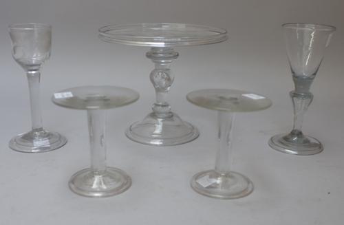 A group of glass, 18th/19th century, comprising; a tazza with galleried circular top, raised on a baluster stem and domed foot, 14cm high; a plain-ste