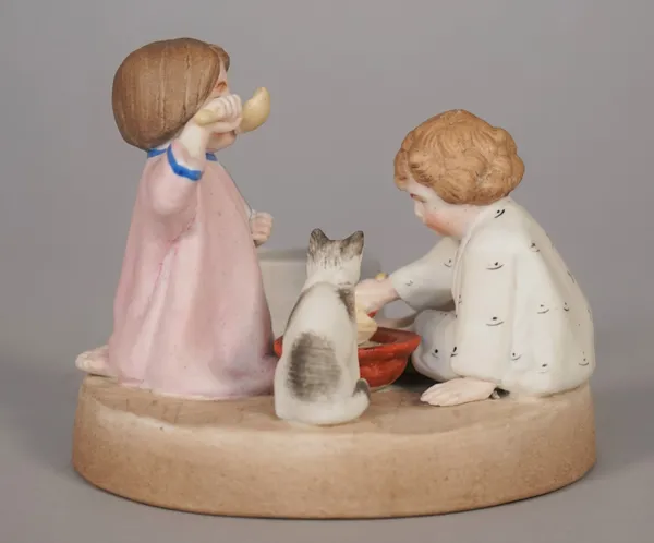 A Russian biscuit porcelain figure group of two small children and a cat drinking milk from a bowl, Gardner Factory, late 19th century, red printed ma