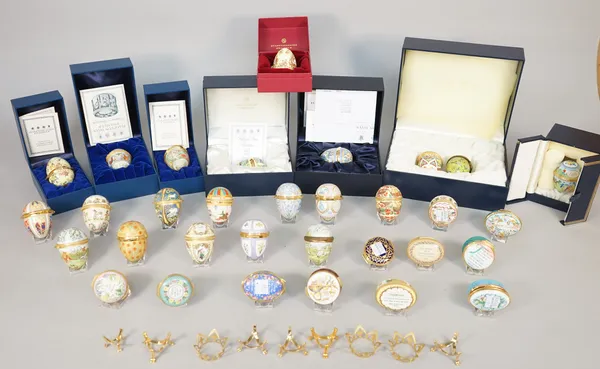 Fifty seven Halcyon Days and Bilston enamel eggs and trinket boxes, all commemorating Easter wares and similar, some boxed, (57).