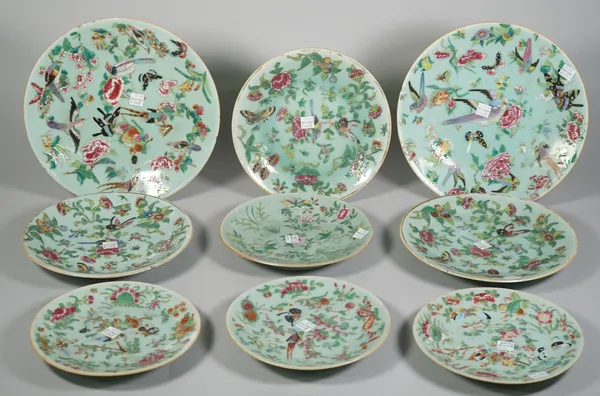 A group of fifteen Chinese celadon-ground plates, 19th century, in four sizes, painted in famille-rose enamels with birds, flowers, fruit and insects,