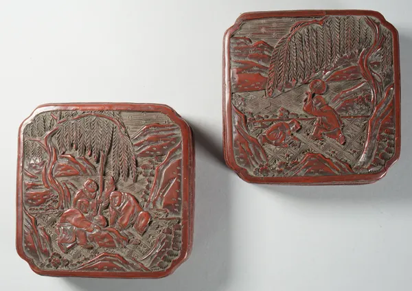 A pair of Chinese cinnabar lacquer boxes and covers, 19th century, of square form with canted corners, carved in relief with figures at leisure, the s