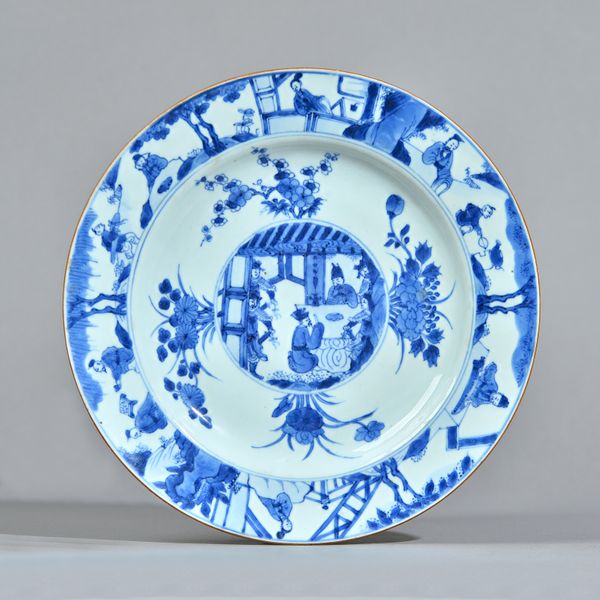 Four Chinese blue and white plates, Kangxi, each painted in the centre with a slightly raised circular panel enclosing a gathering of officials, on a