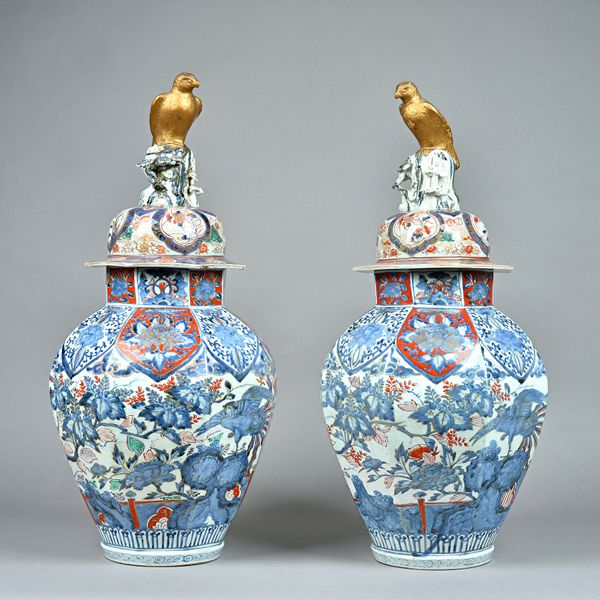 A large pair of Japanese Arita octagonal vases and covers, Edo period, circa 1700, painted in underglaze-blue and enamels, each painted with two ho-o