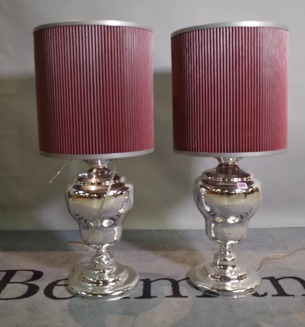 A pair of 20th century silvered glass table lamps of baluster form, with red mesh shades, 85cm high, (2).