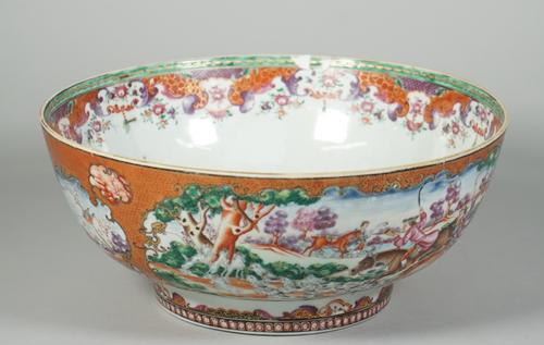 A Chinese export famille-rose hunting punch bowl, Qianlong, painted with large panels of European equestrian huntsmen and hounds in pursuit of a hare