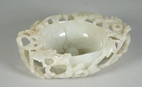 A Chinese pale celadon jade `floral' brush washer, 17th century or possibly later, modelled in the form of a flower with domed centre and four curved