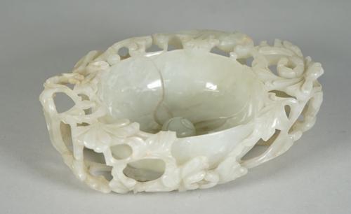 A Chinese pale celadon jade `floral' brush washer, 17th century or possibly later, modelled in the form of a flower with domed centre and four curved