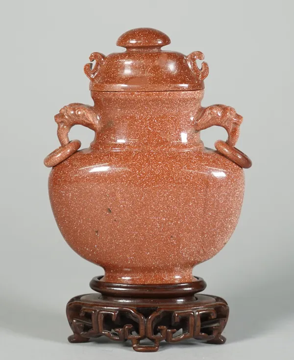 A Chinese aventurine glass two handled vase and cover, 18th/19th century, of flattened baluster form, set with animal mask and ring handles, 12cm. hig