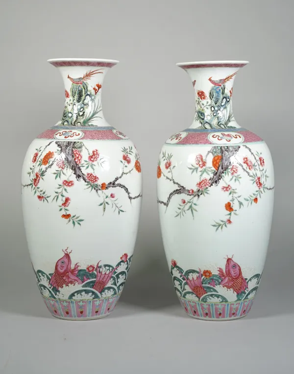 A pair of Chinese famille-rose vases, 19th century, each ovoid body finely enamelled with two carp amongst foaming waves beneath overhanging branches