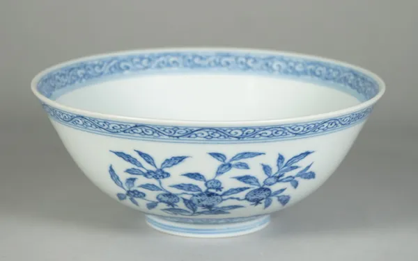 A Chinese blue and white bowl, Daoguang seal mark in underglaze-blue and probably of the period, the exterior painted with branches of fruiting peach,