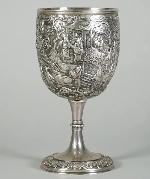 A good Chinese export silver standing cup, mark of Sheng Chang, late 19th century, the deep bowl decorated in repoussé with a battle scene of foot sol