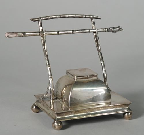 A Chinese export silver inkstand and pen, attributed to the firm of Hung Chong, late 19th/early 20th century, the stand of rectangular form set on fou