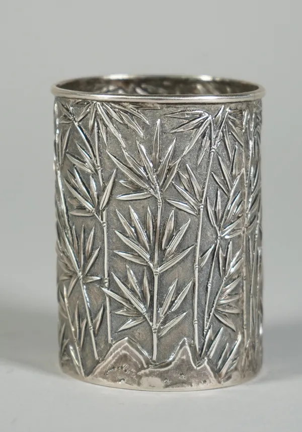 A Chinese export silver beaker, mark of Wang Hing, late 19th/early 20th century, of cylindrical form, the sides decorated in repoussé with bamboo and