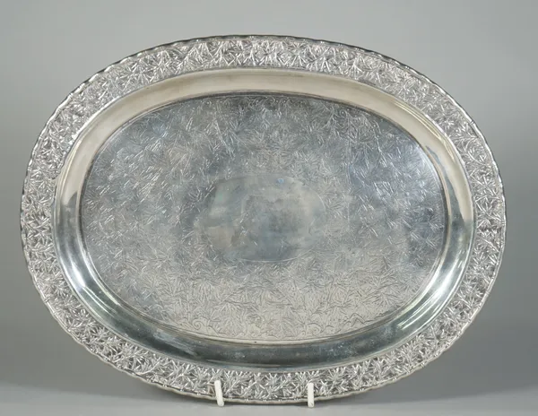 A Chinese export silver salver, mark of Hoaching, late 19th century, of oval form, the centre chased with bamboo and rocks around a central plain oval