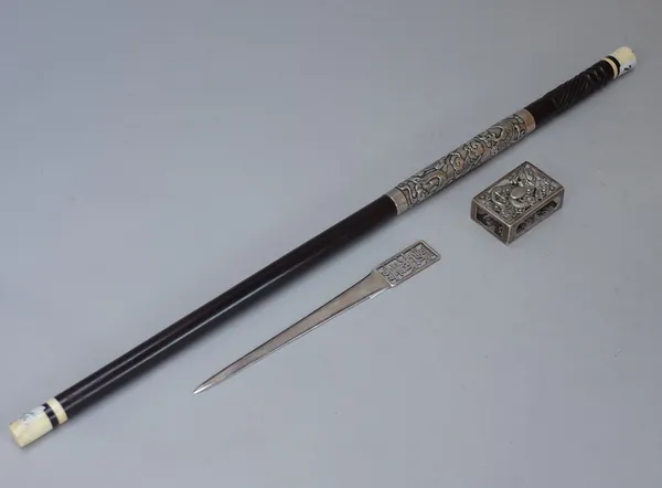 An Anglo Chinese ebony and ivory mounted swagger stick, late 19th/early 20th century, with wide silver collar decorated in repoussé with a dragon amon