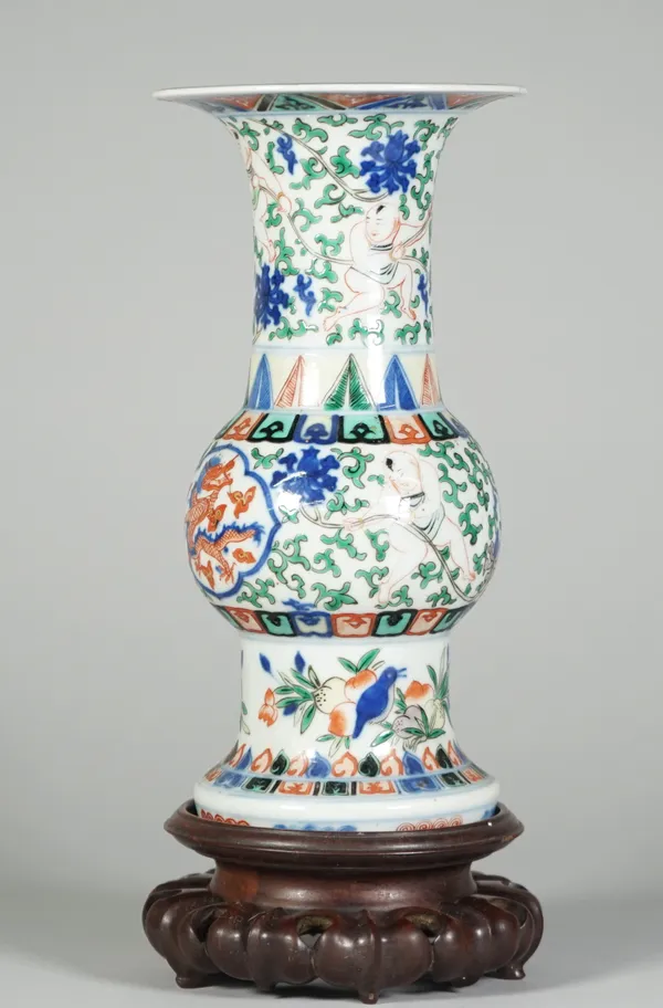 A Chinese porcelain vase (gu), six character Wanli mark, but 19th century, painted in a wucai palette with two central panels of dragons, against a gr