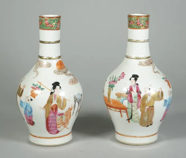 A pair of Canton famille-rose bottle vases, 19th century, each painted with figures beneath a ribbed cylindrical neck, 19cm.high, (2).