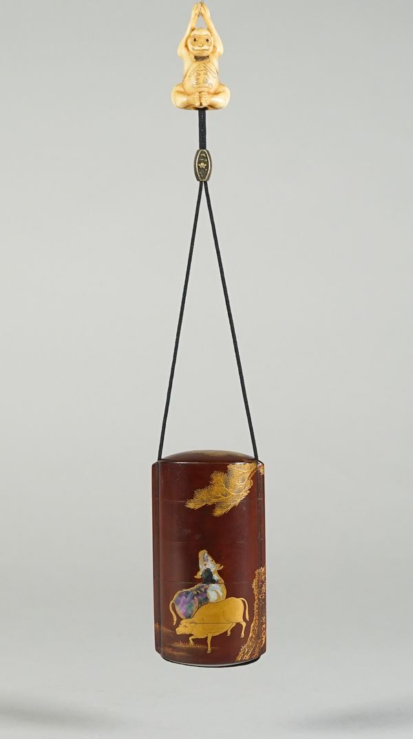 A Japanese brown- ground four-case inro, 19th century, decorated in gold lacquer and shell with three oxen beneath a pine tree, the interior of nashij