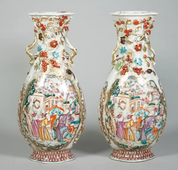 A pair of Chinese export mandarin palette two-handled vases, Qianlong, each flattened pear shaped body painted on each side with figurative panels, th