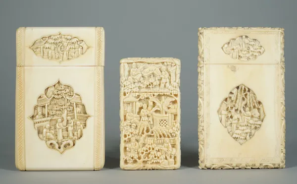 Three Canton ivory rectangular card cases, late 19th century, the smaller example profusely carved with figures, trees and pavilions, 8.25cm. high, th
